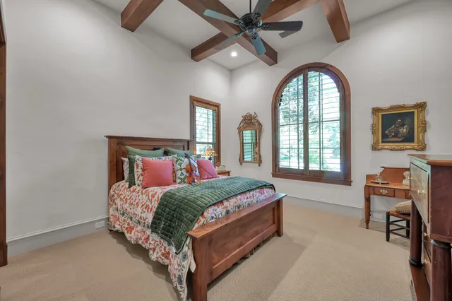 a bedroom with a bed chair and a window