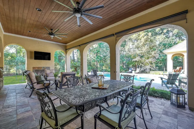 a view of an outdoor dining space with furniture and garden view