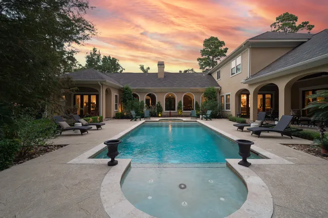 a view of a house with swimming pool and porch