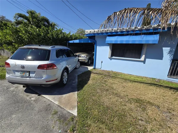 a front view of a house with parking space