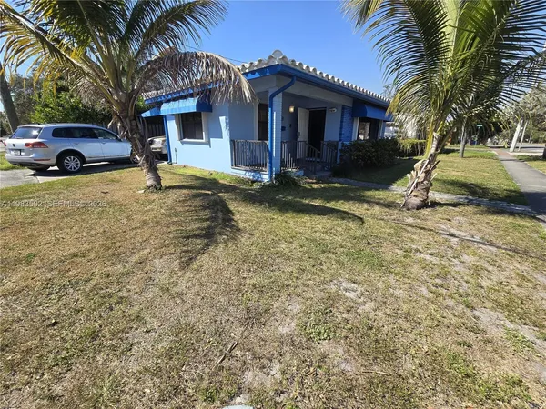 a view of house with outdoor space and swimming pool