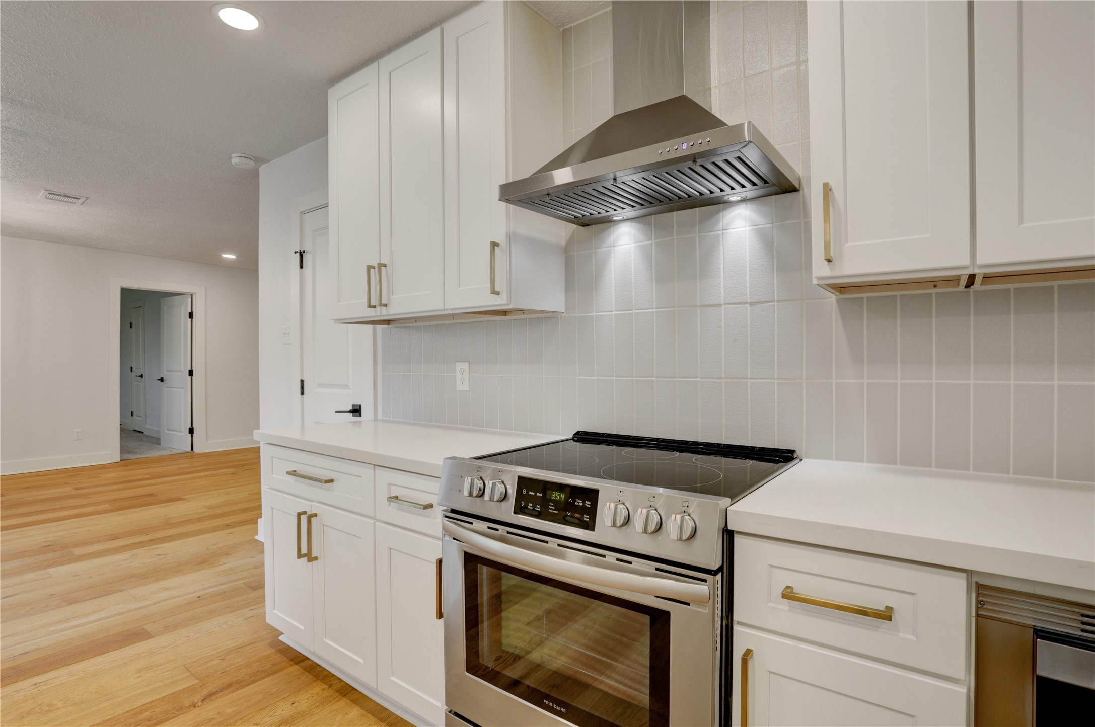 5514 Indigo Street Houston, TX 77096 - Photo 13 of 22 a kitchen with granite countertop white cabinets and white appliances