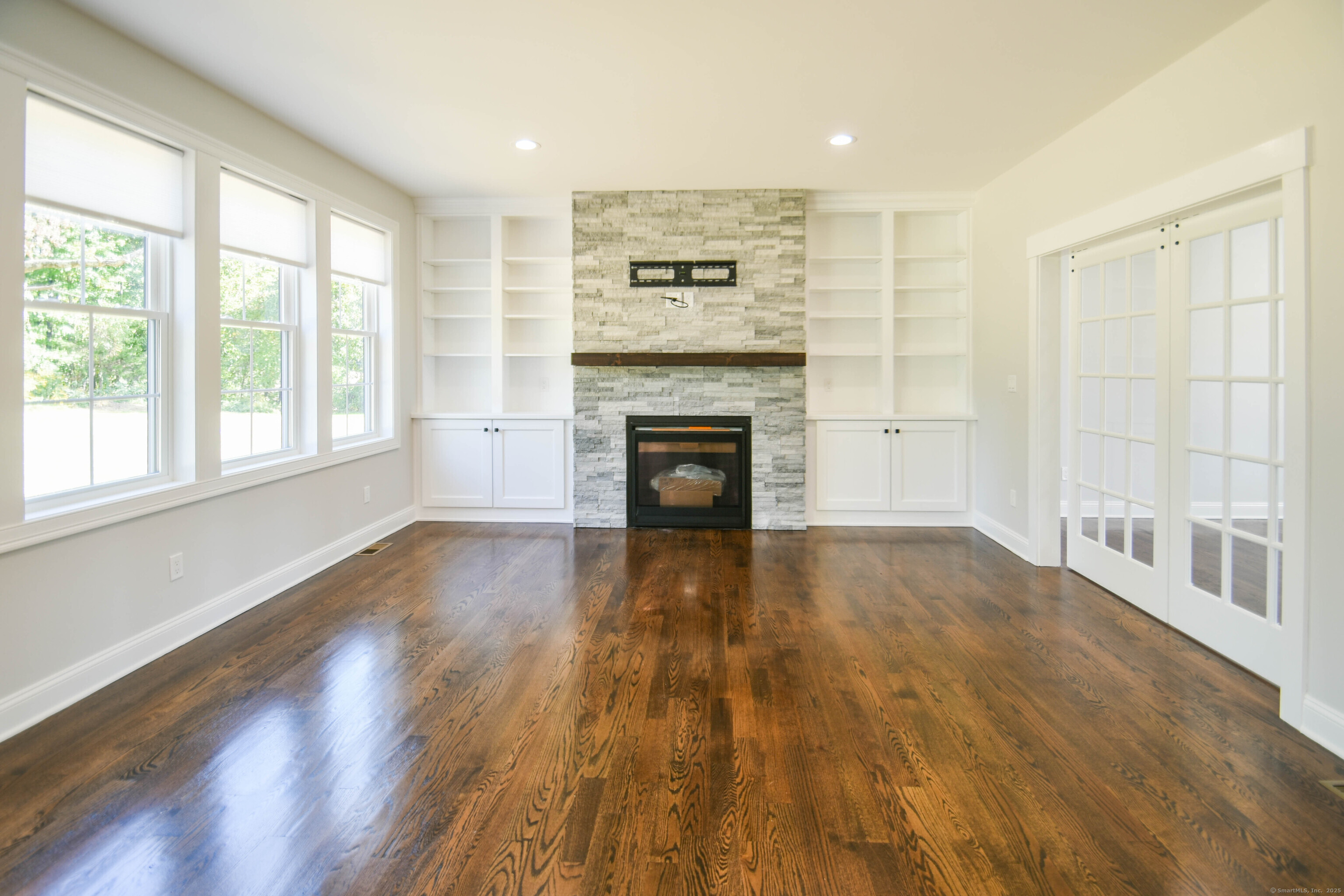 1481 Marion Road Cheshire, CT 06410 - Photo 27 of 30 a view of a livingroom with wooden floor and a fireplace