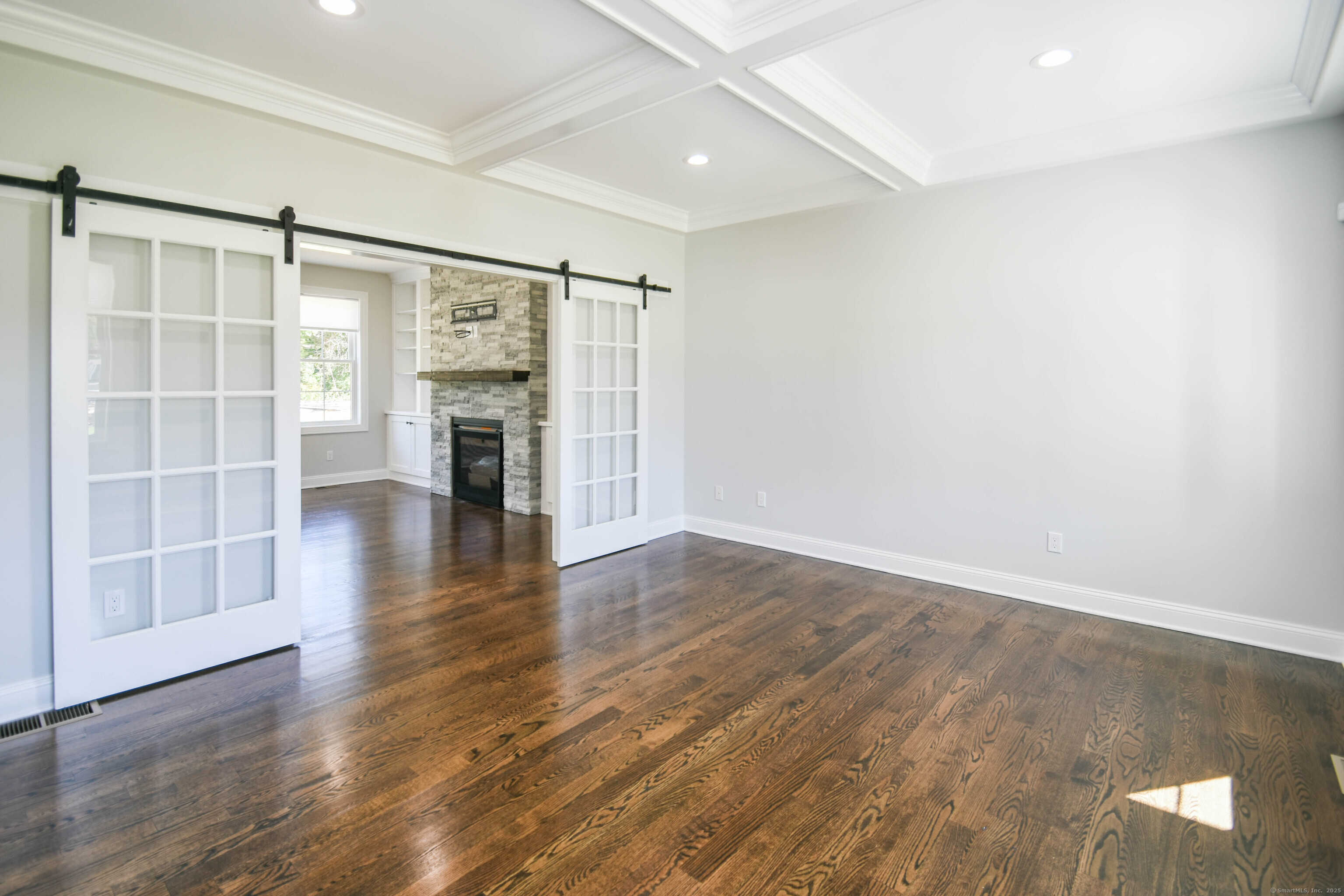 1481 Marion Road Cheshire, CT 06410 - Photo 30 of 30 an empty room with wooden floor and fireplace