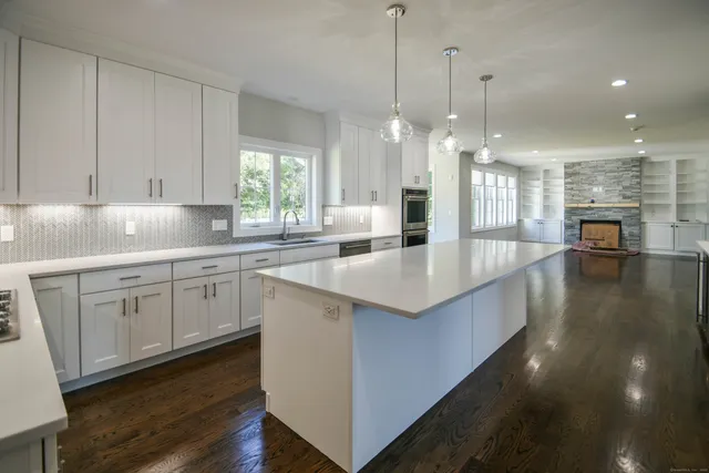 a kitchen with kitchen island a counter space a sink and appliances