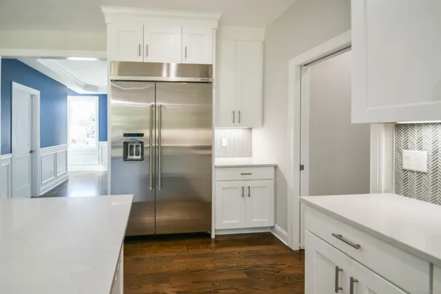a kitchen with a sink and a wooden floor