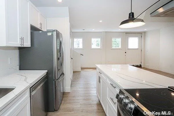 a kitchen with a sink a stove and a refrigerator