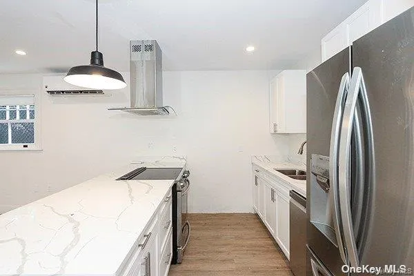 a kitchen with stainless steel appliances a sink a stove and a refrigerator