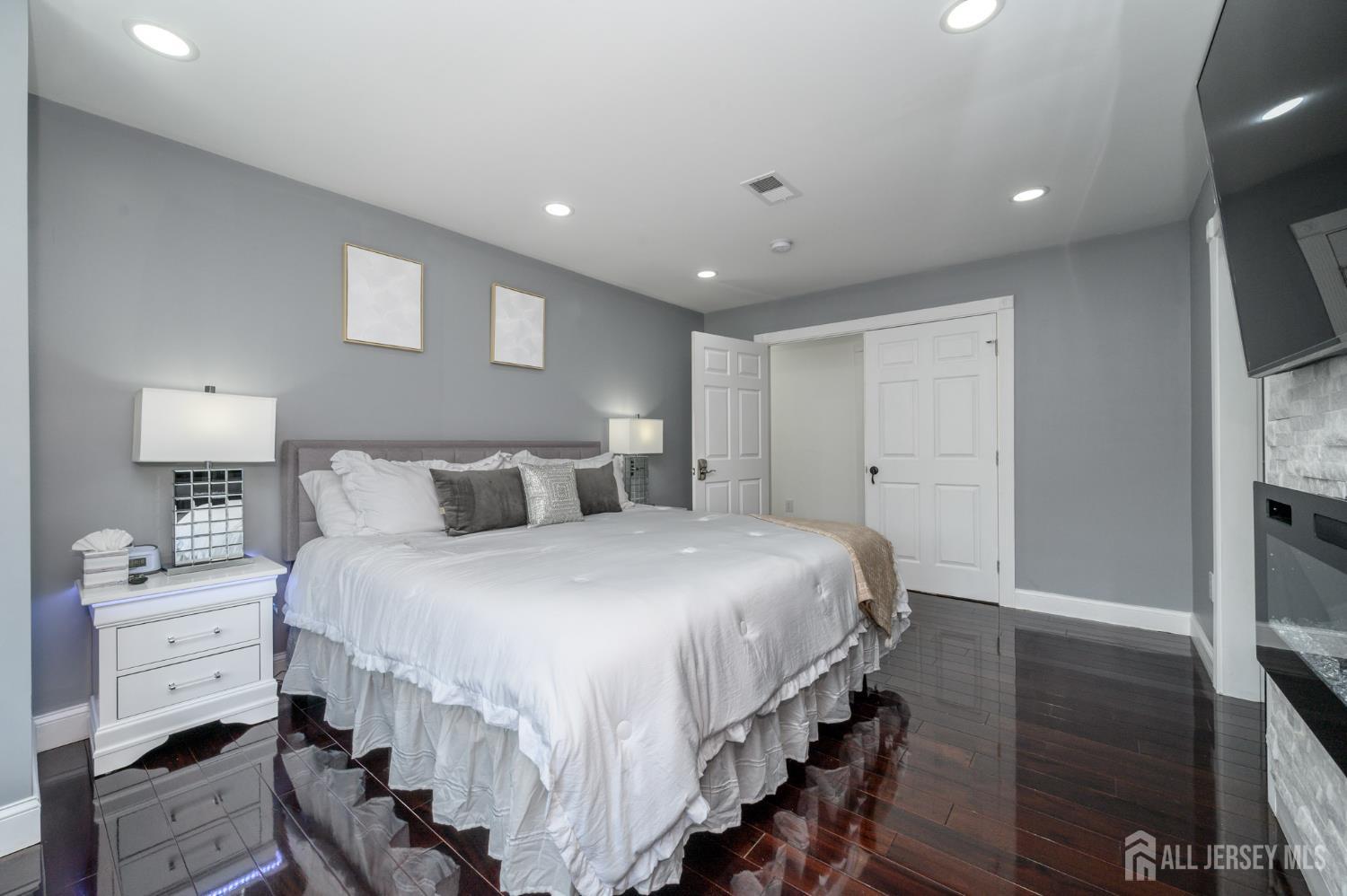 289 Indiana Street Union, NJ 07083 - Photo 21 of 45 a bedroom with a bed and a flat tv screen on dresser