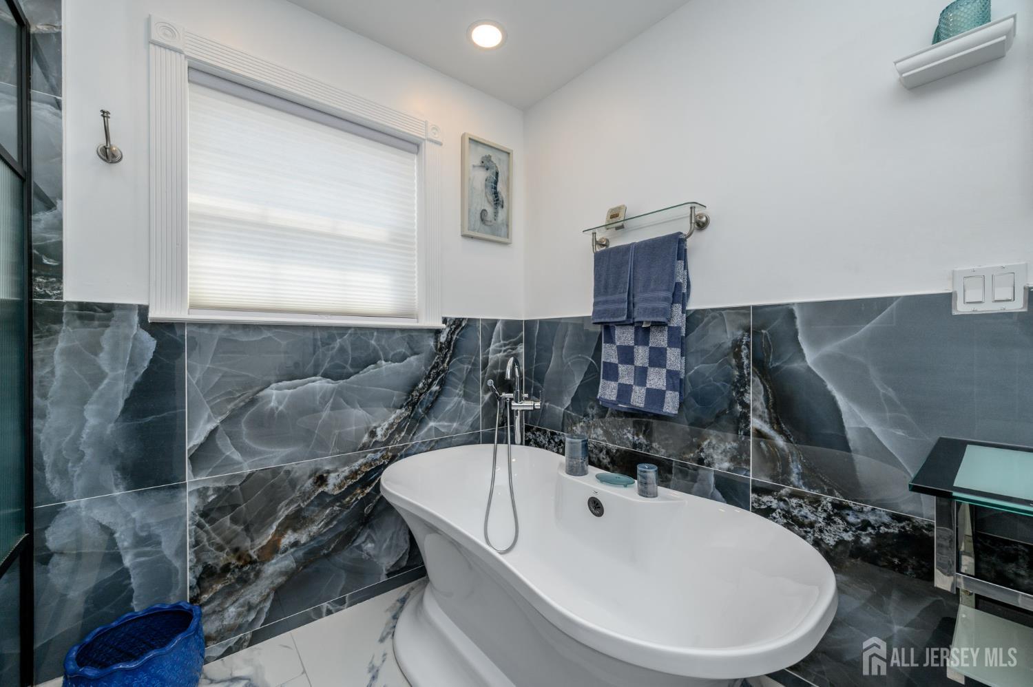 289 Indiana Street Union, NJ 07083 - Photo 24 of 45 a bathroom with a sink and a mirror
