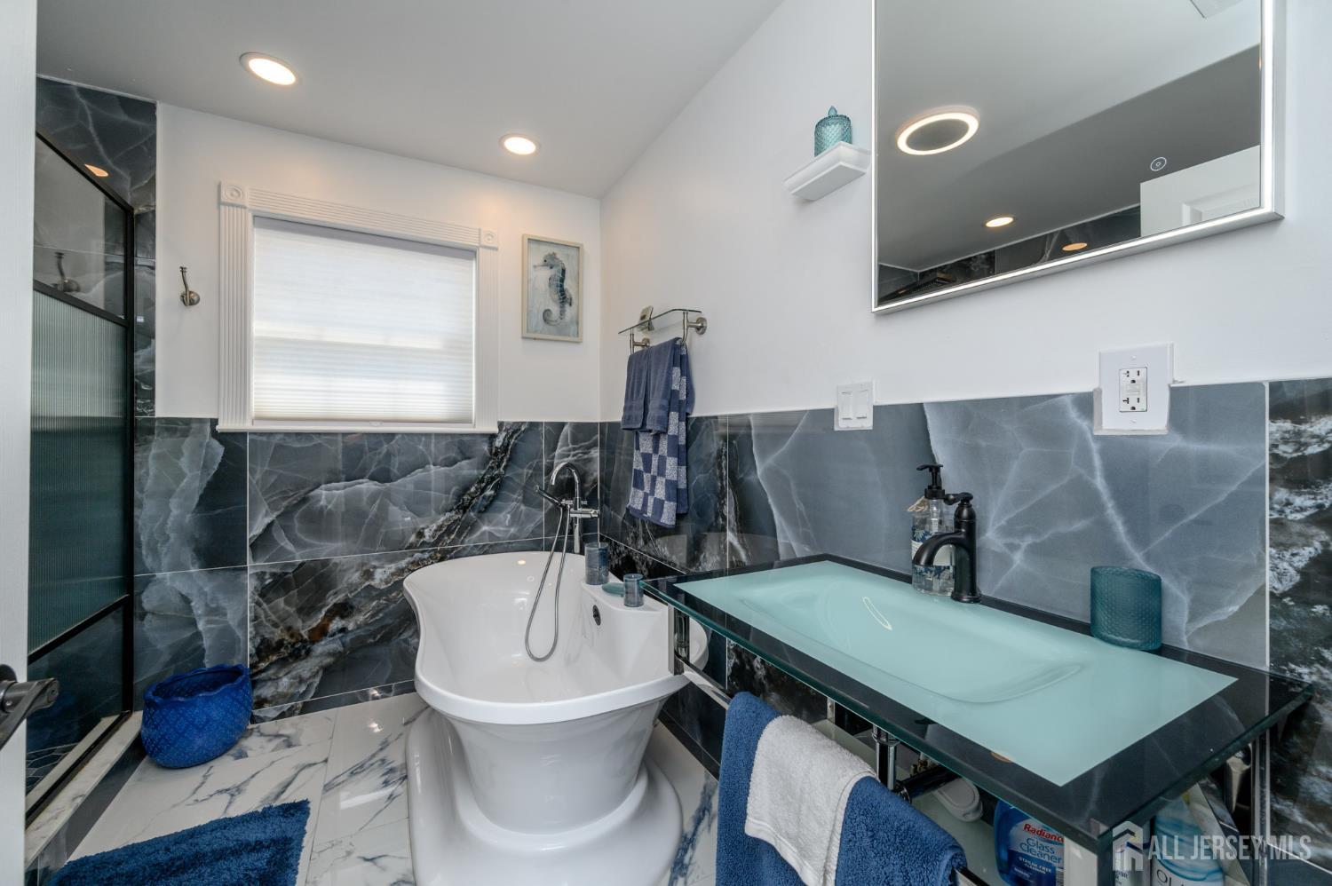 289 Indiana Street Union, NJ 07083 - Photo 25 of 45 a bathroom with a sink a toilet and a mirror