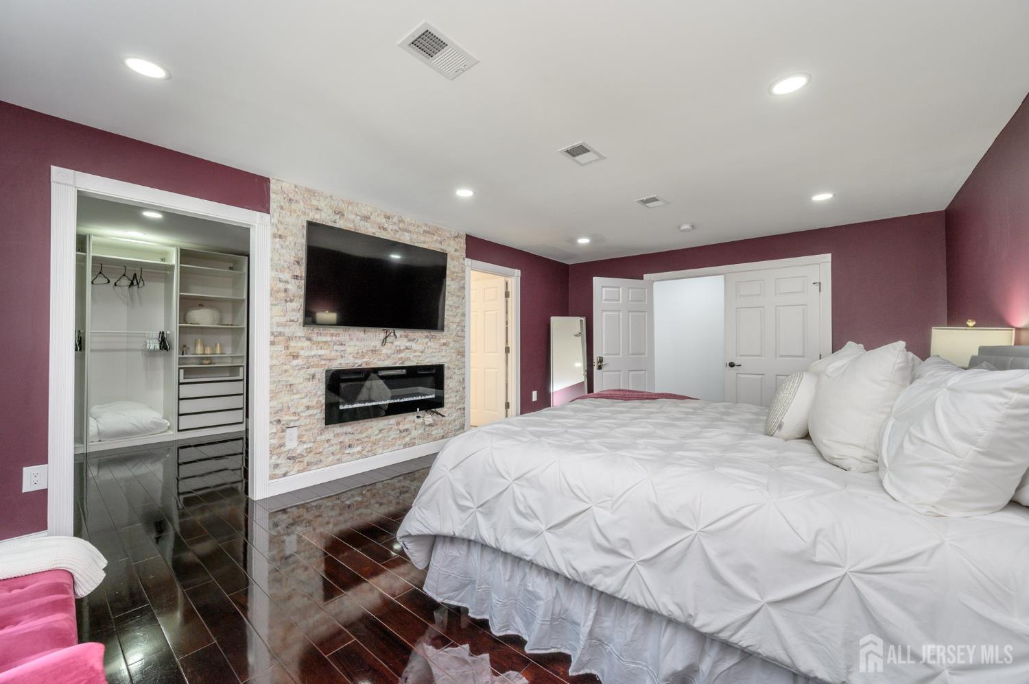 289 Indiana Street Union, NJ 07083 - Photo 31 of 45 a spacious bedroom with a bed and a flat screen tv