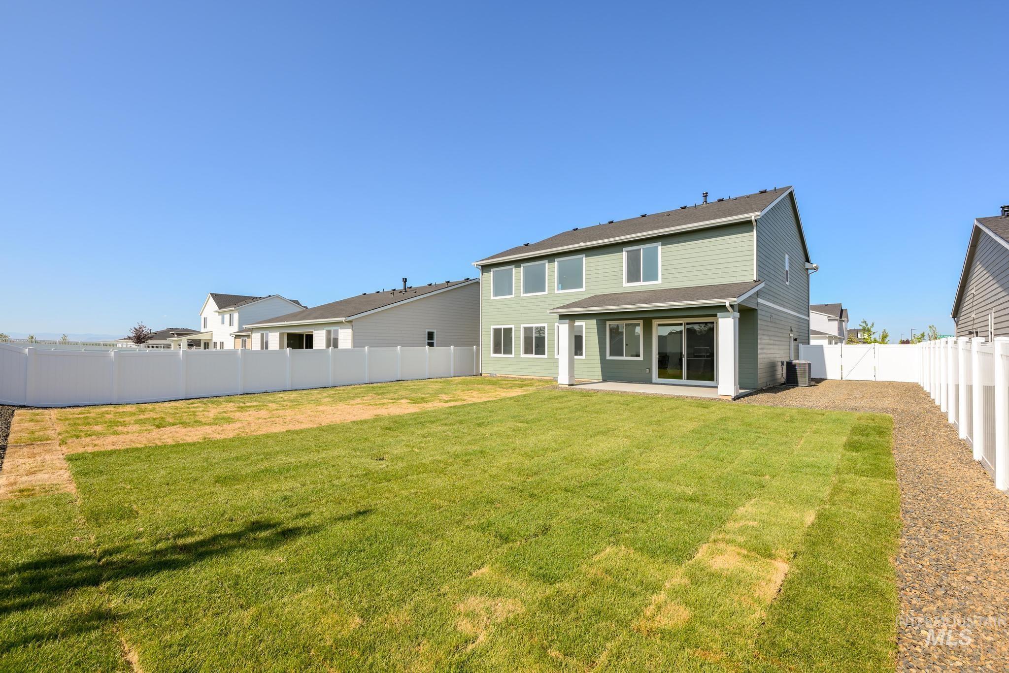 1922 West Declan Street Kuna, ID 83634 - Photo 9 of 9 Rear view of property featuring a fenced backyard and a patio area