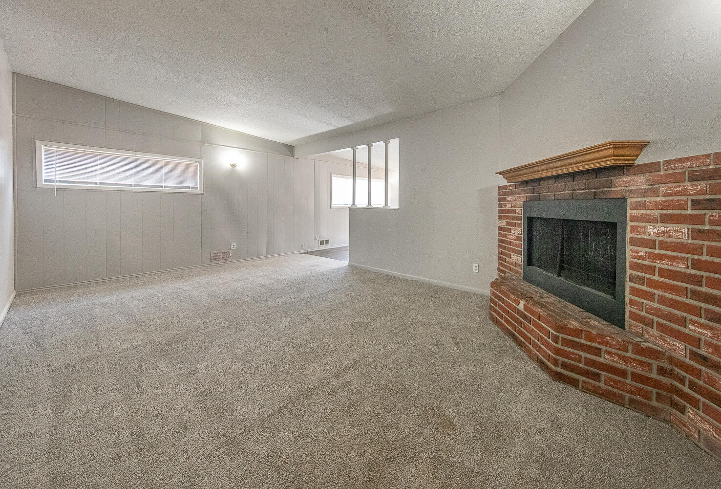 4409 44th Street Lubbock, TX 79414 - Photo 2 of 26 a view of an empty room with wooden floor and a fireplace