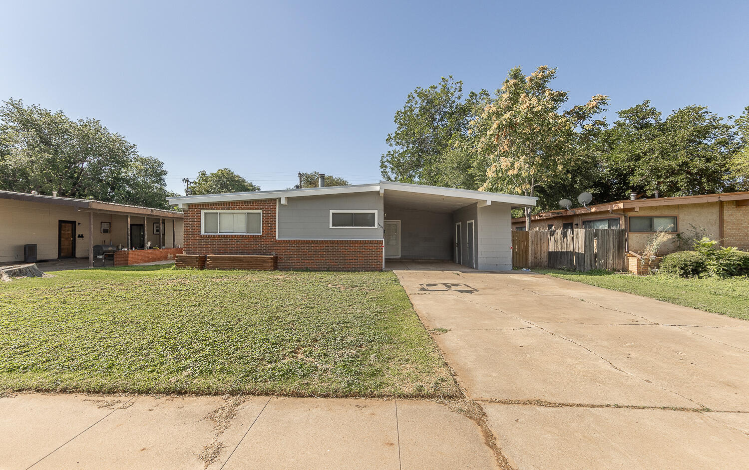 4409 44th Street Lubbock, TX 79414 - Photo 25 of 26 a front view of a house with a garden and trees