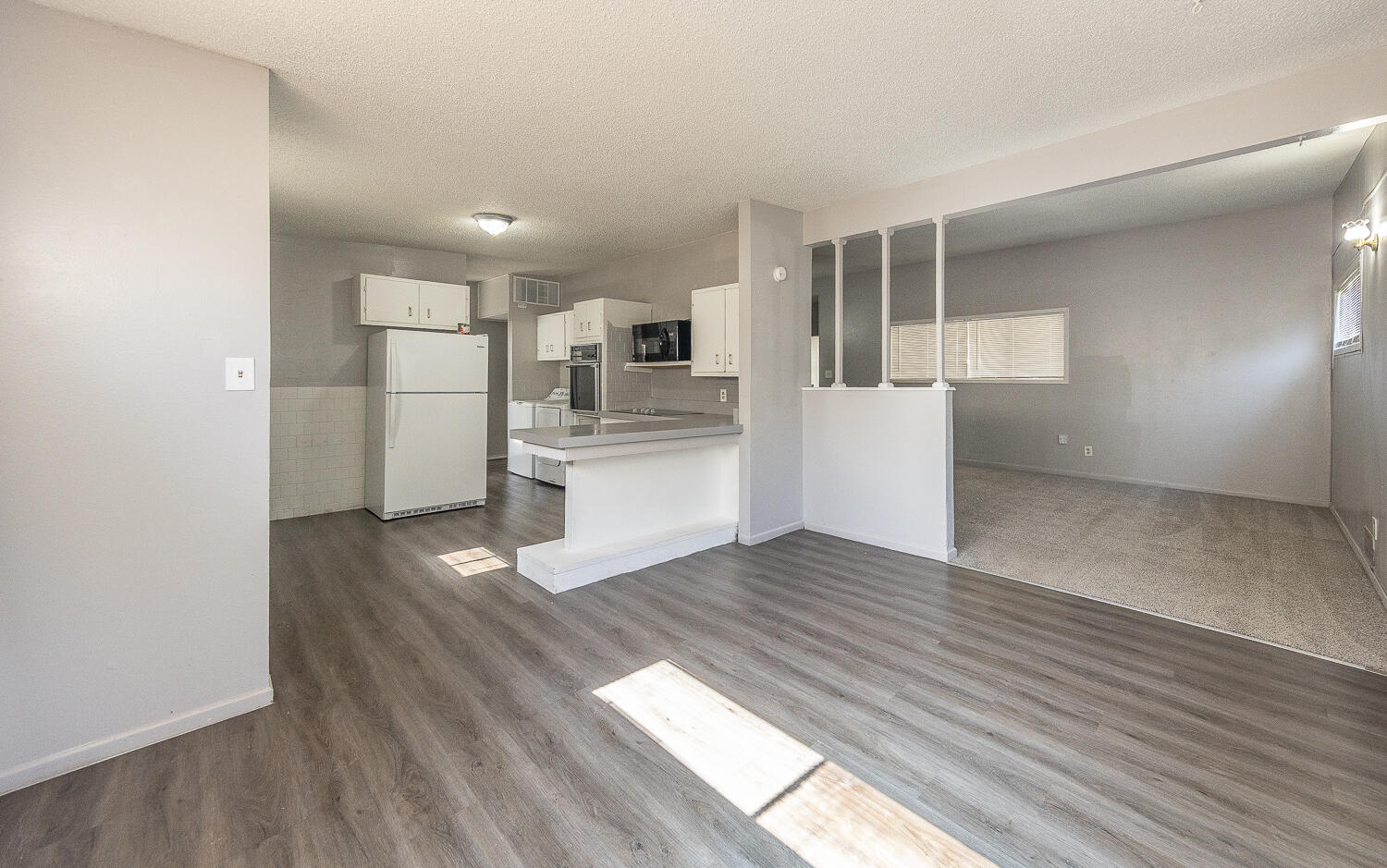 4409 44th Street Lubbock, TX 79414 - Photo 8 of 26 a view of a kitchen with wooden floor and electronic appliances