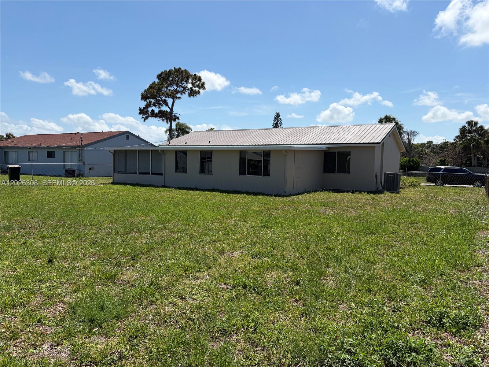 653 Atlas Avenue Northeast Palm Bay, FL 32905 - Photo 21 of 22 a view of a house with a yard and a garden