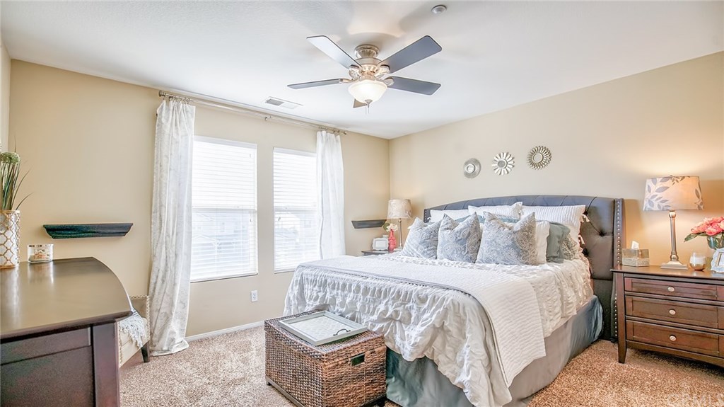 7331 Shelby Place, Unit 23 Rancho Cucamonga, CA 91739 - Photo 16 of 48 a bedroom with a bed and a chandelier