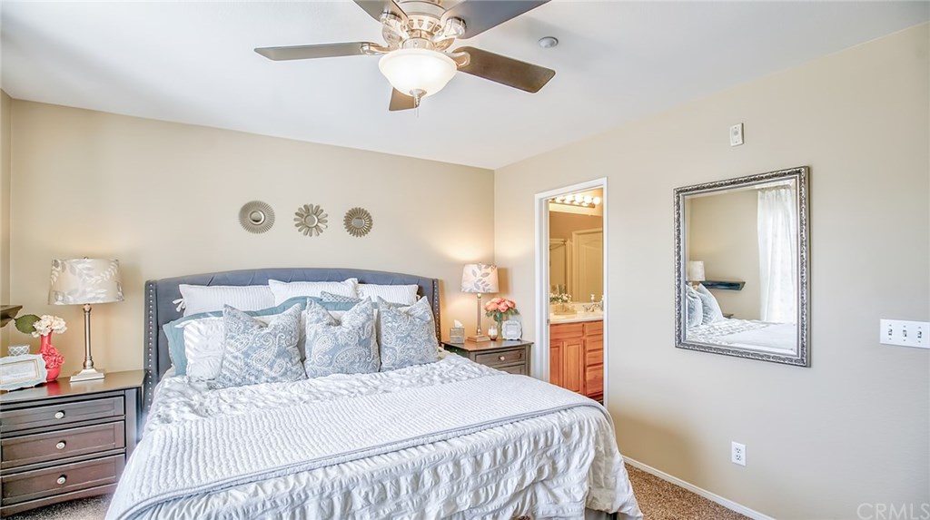 7331 Shelby Place, Unit 23 Rancho Cucamonga, CA 91739 - Photo 17 of 48 a bedroom with a bed and a chandelier