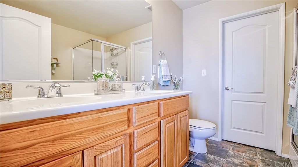 7331 Shelby Place, Unit 23 Rancho Cucamonga, CA 91739 - Photo 19 of 48 a bathroom with a granite countertop sink mirror vanity and toilet
