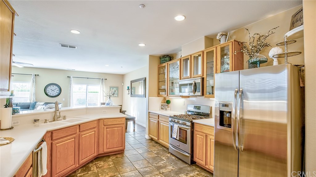 7331 Shelby Place, Unit 23 Rancho Cucamonga, CA 91739 - Photo 4 of 48 a kitchen with stainless steel appliances granite countertop a sink and cabinets