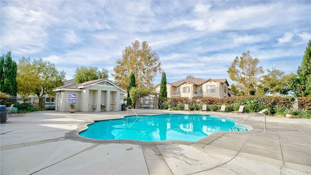 7331 Shelby Place, Unit 23 Rancho Cucamonga, CA 91739 - Photo 35 of 48 a view of a white house with a big yard and large trees