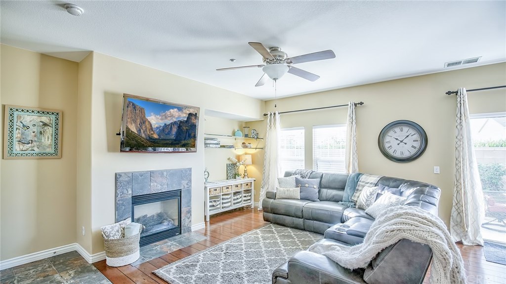 7331 Shelby Place, Unit 23 Rancho Cucamonga, CA 91739 - Photo 10 of 48 a living room with furniture a clock and a fireplace