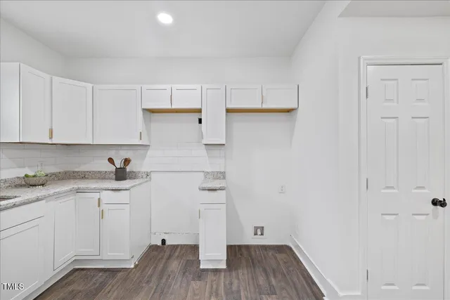 a view of a room with furniture and wooden floor