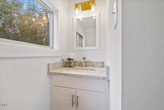 a backyard of a house with large trees and barbeque oven
