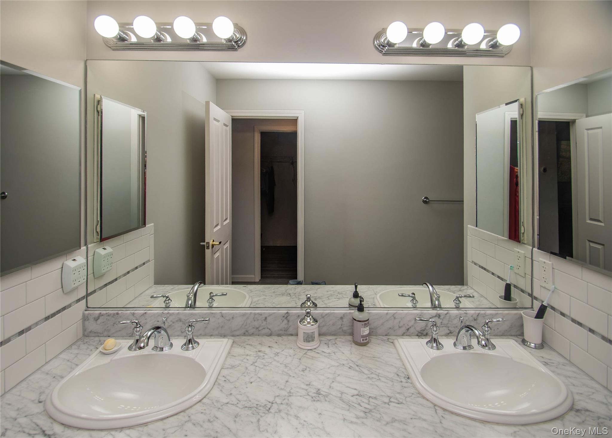 303 Bridgeview Drive Poughkeepsie, NY 12601 - Photo 20 of 25 a bathroom with double vanity sinks and a mirror