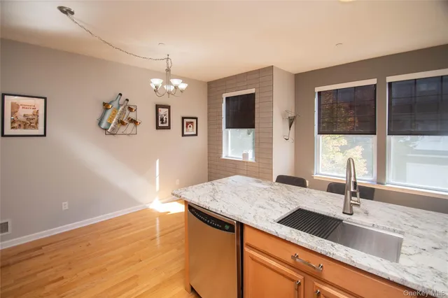 a view of a kitchen with granite countertop cabinets a sink and dishwasher
