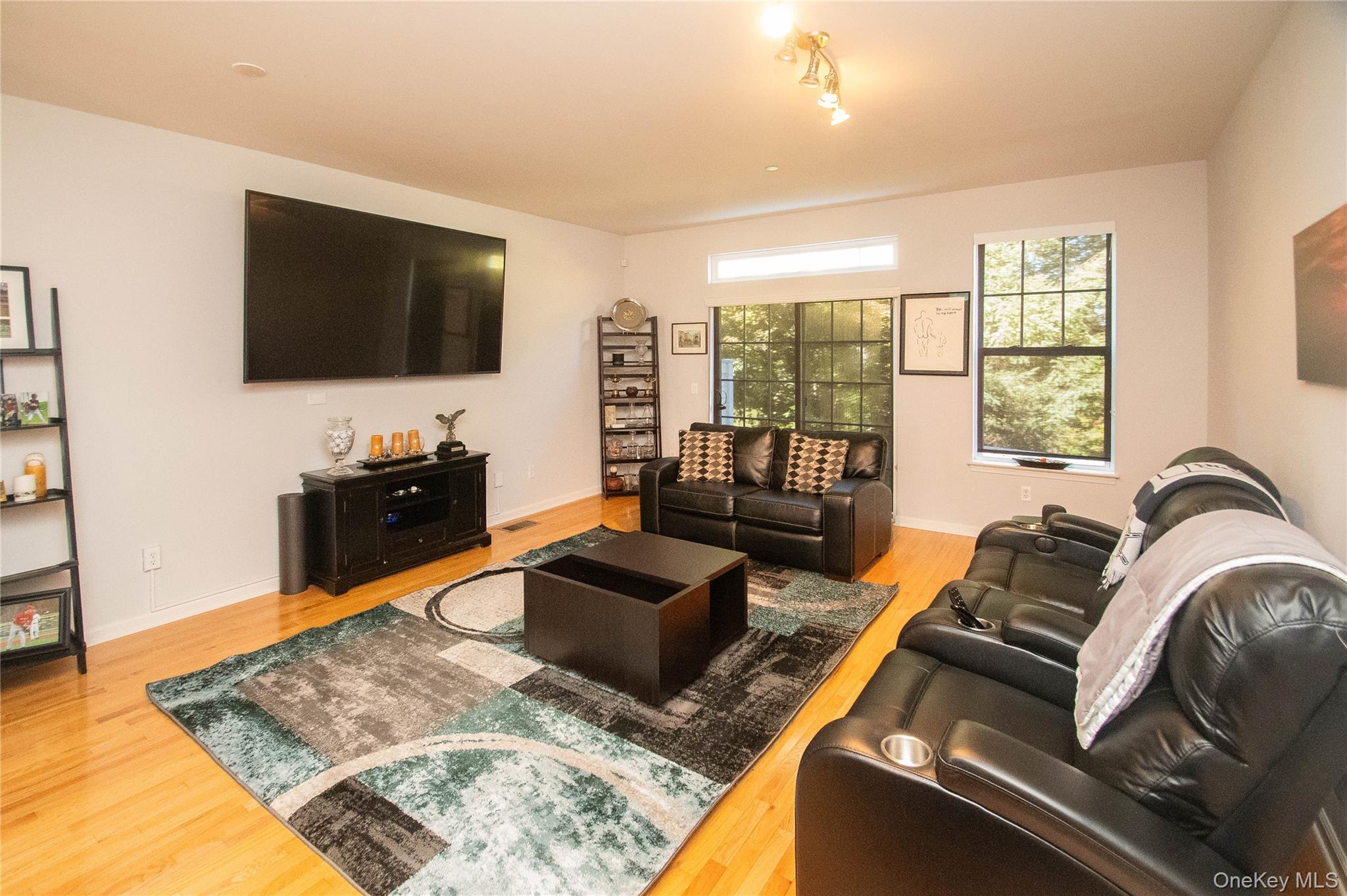 303 Bridgeview Drive Poughkeepsie, NY 12601 - Photo 9 of 25 a living room with furniture and a flat screen tv