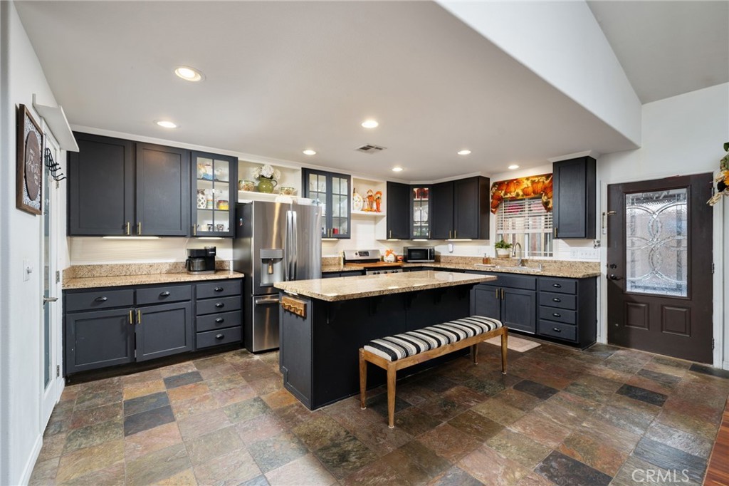7575 Rancho Road Wrightwood, CA 92397 - Photo 12 of 32 a large kitchen with kitchen island a sink stainless steel appliances and cabinets