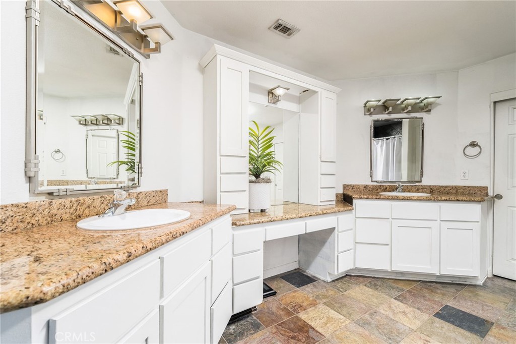 7575 Rancho Road Wrightwood, CA 92397 - Photo 16 of 32 a bathroom with a granite countertop sink and a mirror