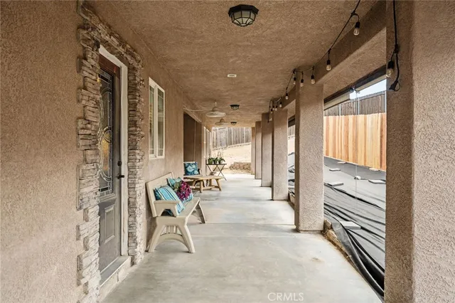 a view of an entryway with wooden floor and a livingroom view