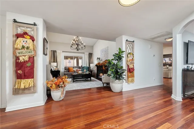 a view of a livingroom with dining room and wooden floor