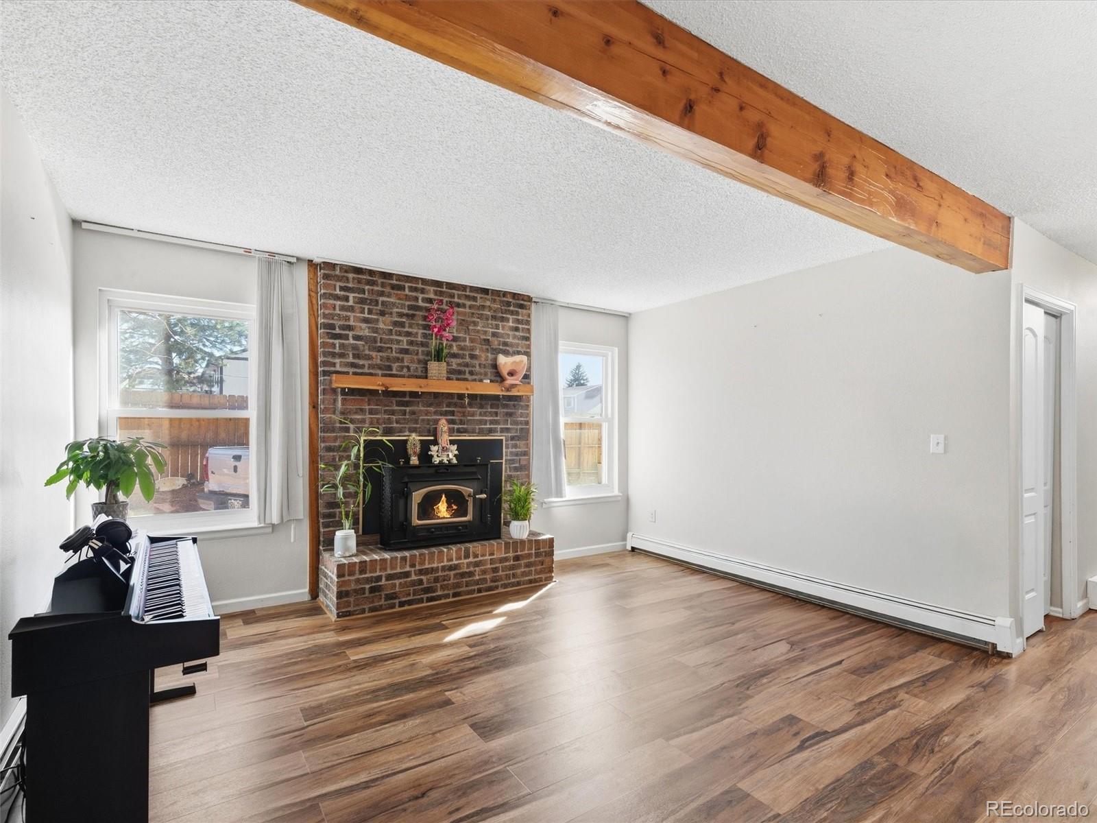 892 South Rifle Way Aurora, CO 80017 - Photo 13 of 32 a living room with furniture and a fireplace