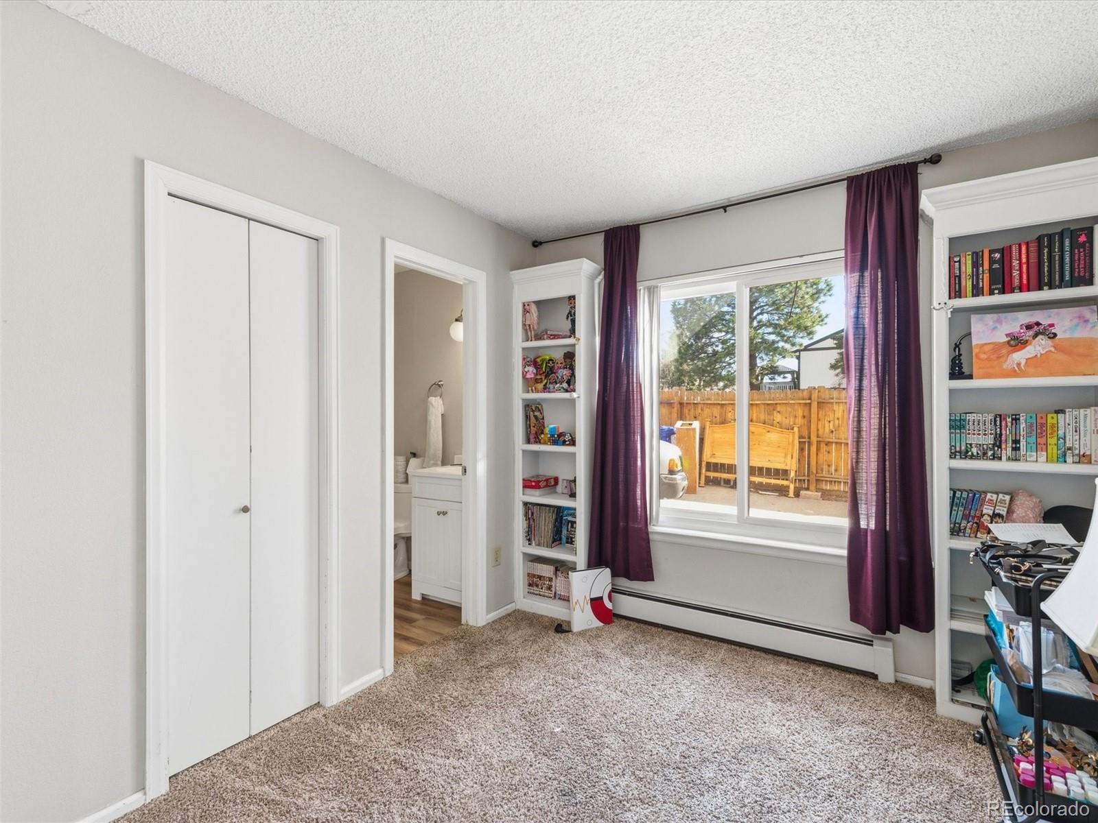 892 South Rifle Way Aurora, CO 80017 - Photo 14 of 32 an empty room with bookshelf and a window