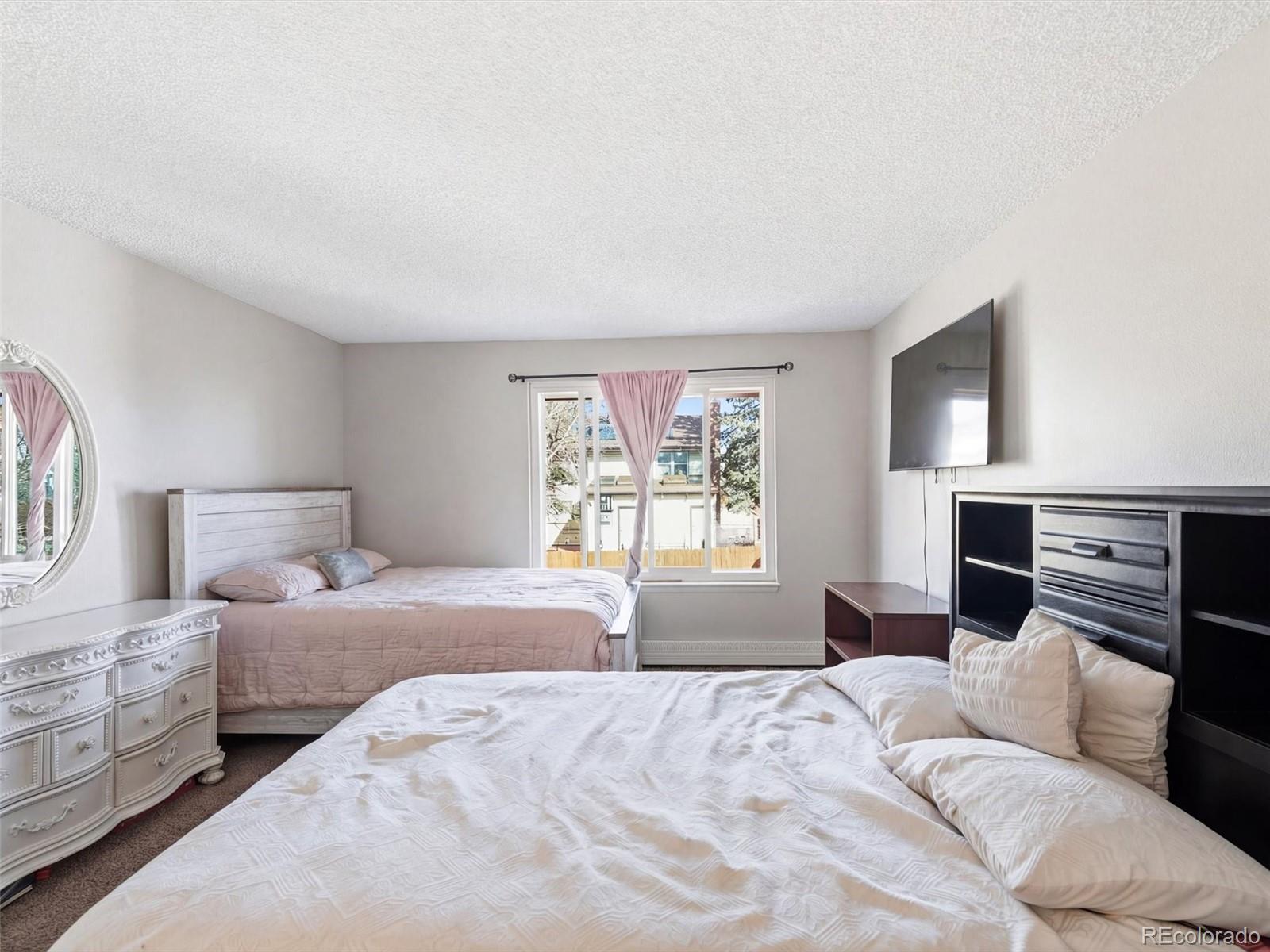 892 South Rifle Way Aurora, CO 80017 - Photo 16 of 32 a bedroom with a bed and a couch