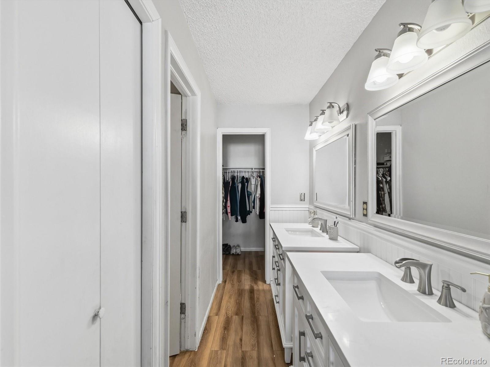 892 South Rifle Way Aurora, CO 80017 - Photo 18 of 32 a en suite bathroom with a sink and mirror