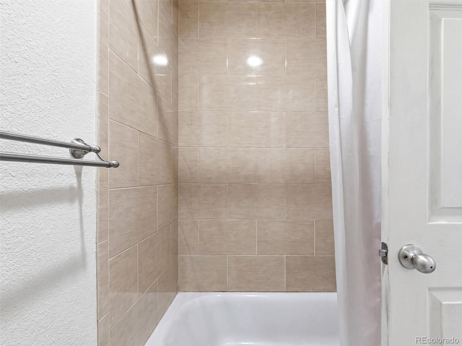 892 South Rifle Way Aurora, CO 80017 - Photo 19 of 32 a bathroom with a shower