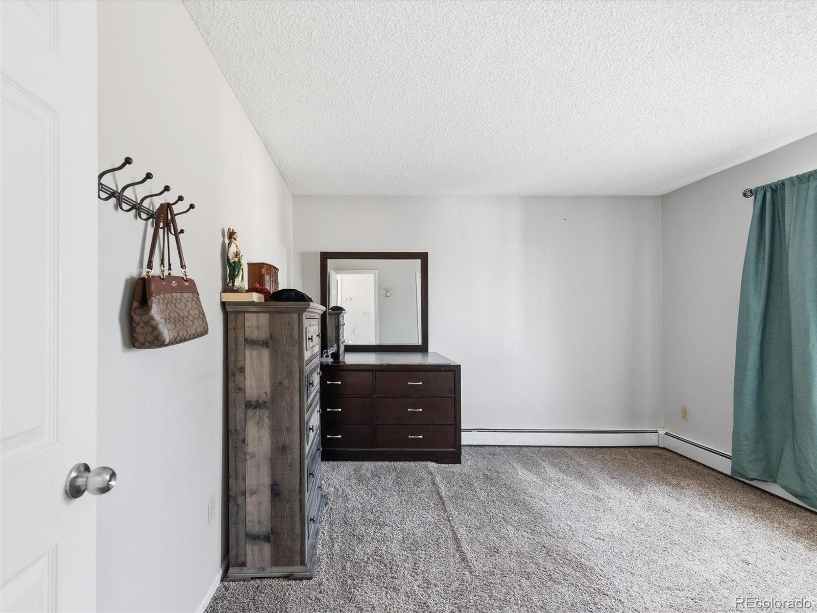 892 South Rifle Way Aurora, CO 80017 - Photo 21 of 32 a room with a refrigerator and cabinets
