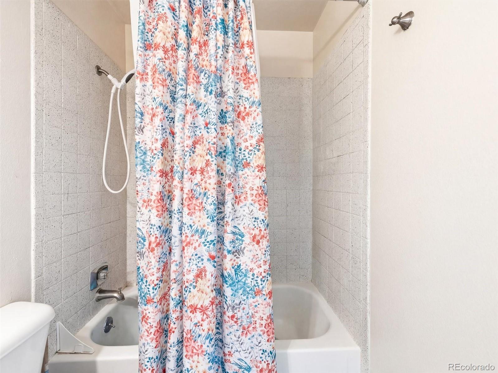892 South Rifle Way Aurora, CO 80017 - Photo 24 of 32 a bathroom with a bathtub and shower