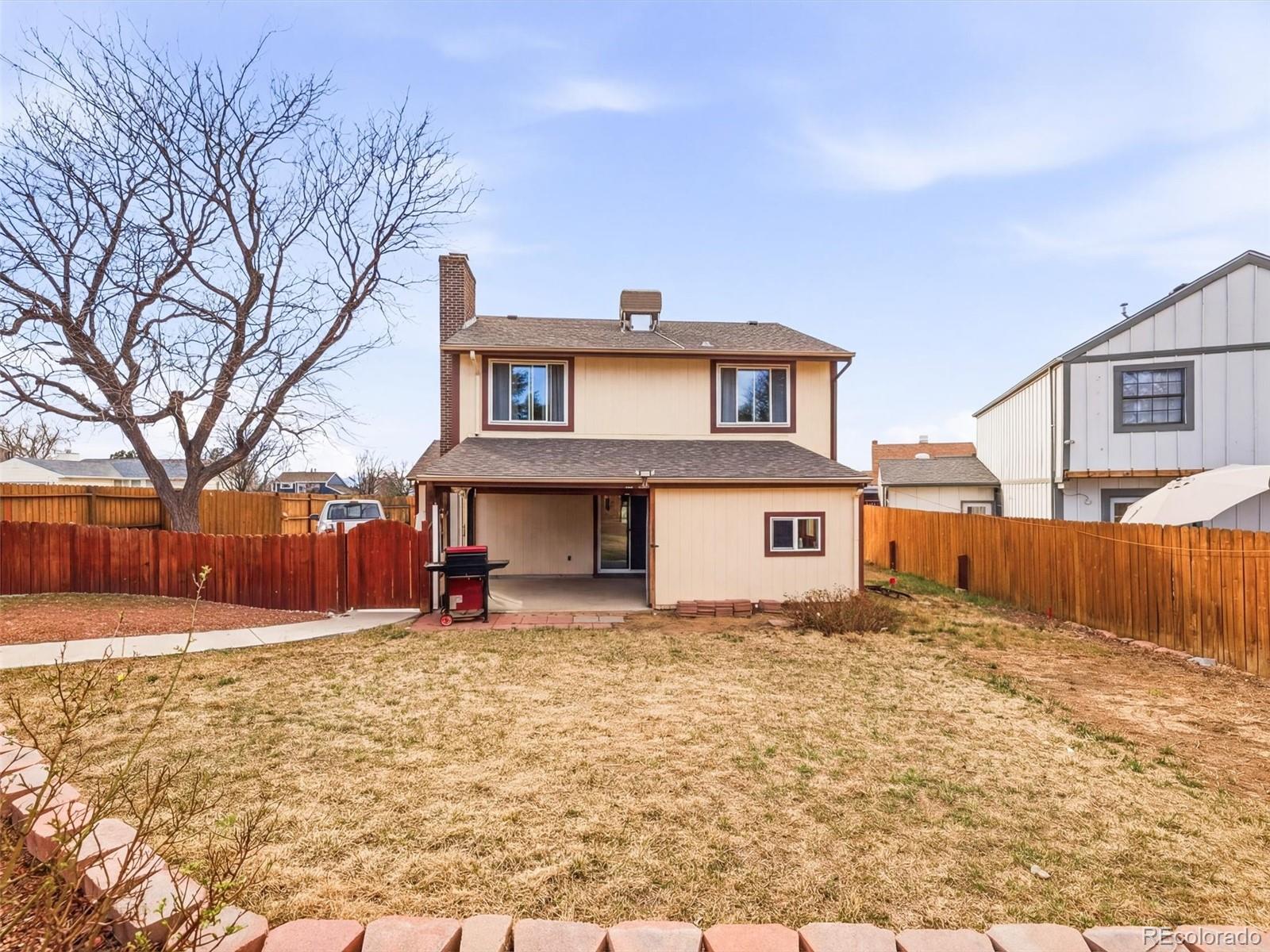 892 South Rifle Way Aurora, CO 80017 - Photo 29 of 32 a house that has a tree in front of it