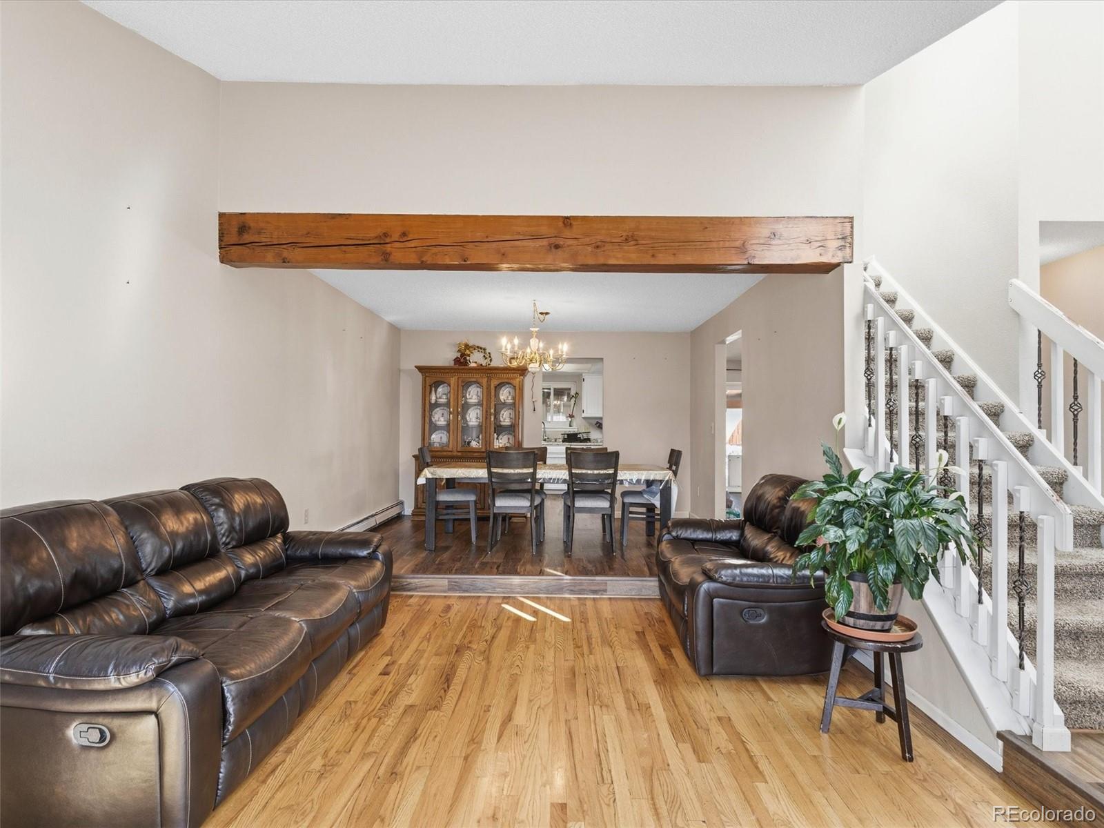 892 South Rifle Way Aurora, CO 80017 - Photo 4 of 32 a living room with furniture and wooden floor