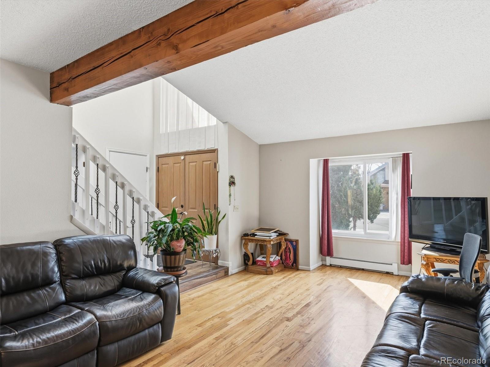 892 South Rifle Way Aurora, CO 80017 - Photo 6 of 32 a living room with furniture and a window