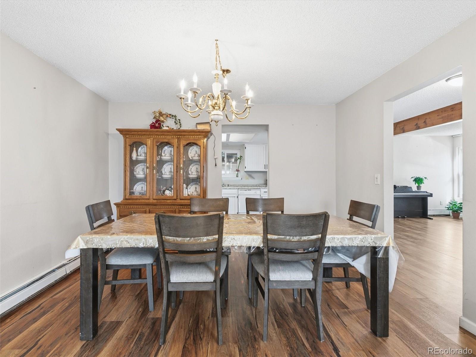 892 South Rifle Way Aurora, CO 80017 - Photo 7 of 32 a view of a dining room with furniture window and wooden floor