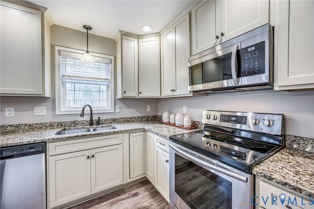 2024 Walnut Tree Place Powhatan, VA 23139 - Photo 12 of 30 a kitchen with stainless steel appliances granite countertop a sink stove and microwave