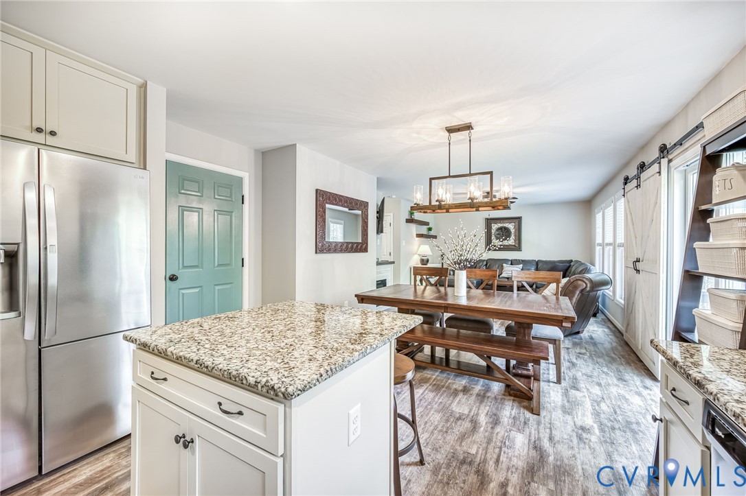 2024 Walnut Tree Place Powhatan, VA 23139 - Photo 13 of 30 a living room with dining table and a refrigerator