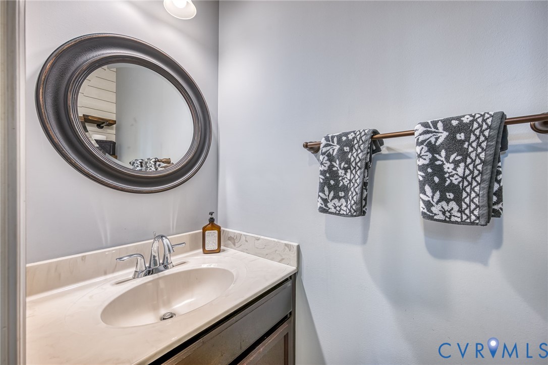 2024 Walnut Tree Place Powhatan, VA 23139 - Photo 14 of 30 a bathroom with a sink and a mirror